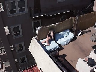 Couple on the rooftop deck filmed by a drone as they fuck